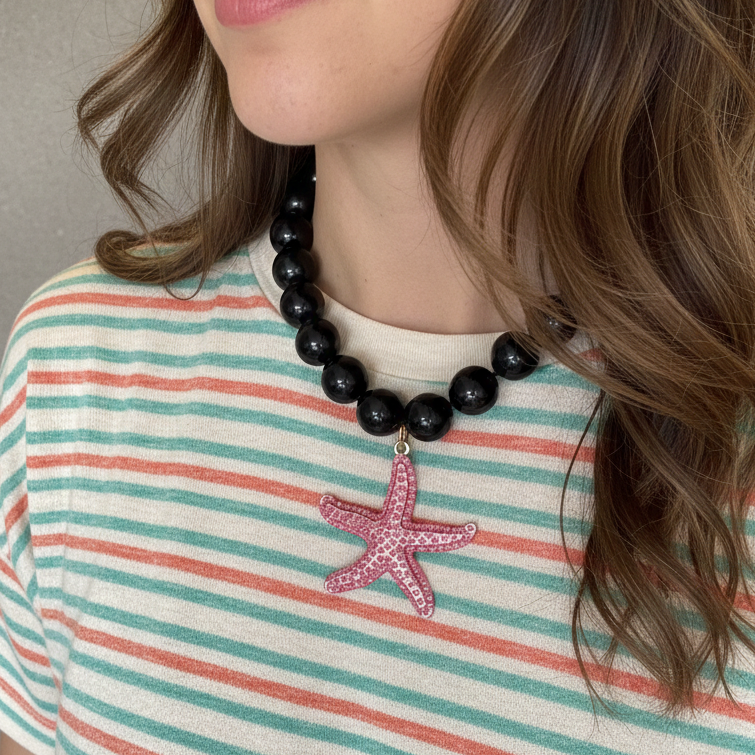 Black obsidian bead necklace with pink starfish pendant and sparkling rhinestones_model