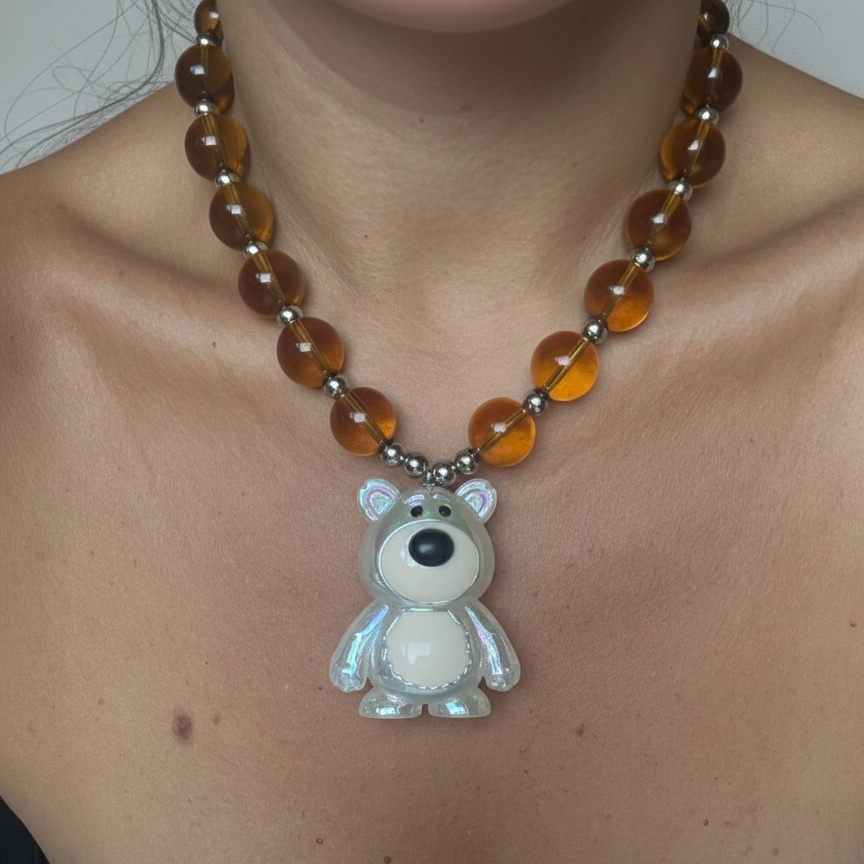 Colorful beaded necklace featuring a statement teddy bear pendant.