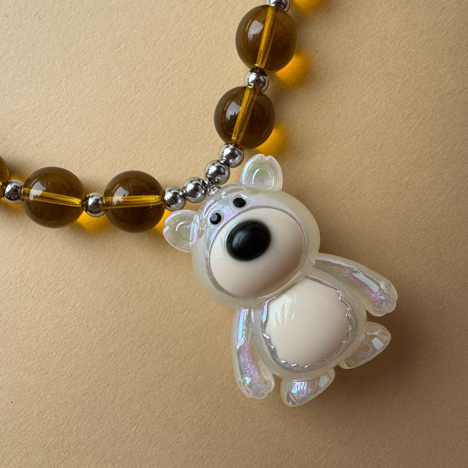 Colorful beaded necklace featuring a statement teddy bear pendant_details