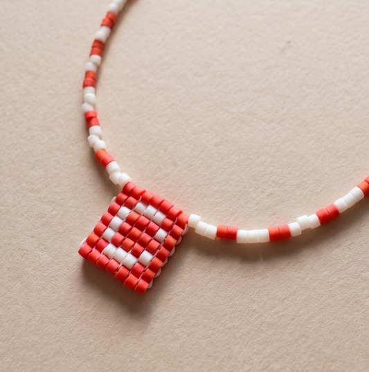 Handmade Miyuki beaded necklace forming a medal-style pendant with an initial letter