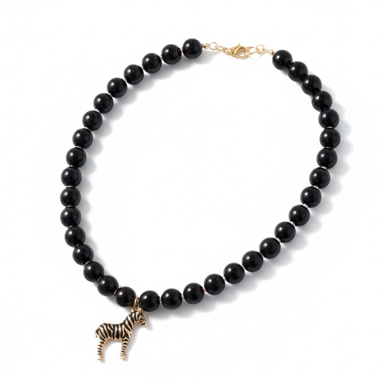Handmade black beaded necklace featuring a zebra pendant_still