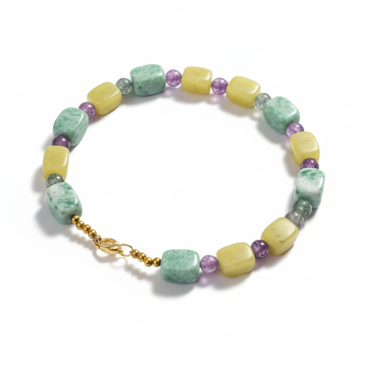Colorful beaded necklace made with green and purple beads_still