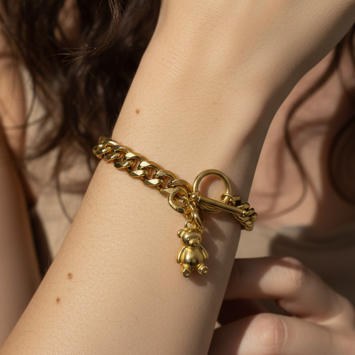 Gold chain bracelet with a teddy bear charm 