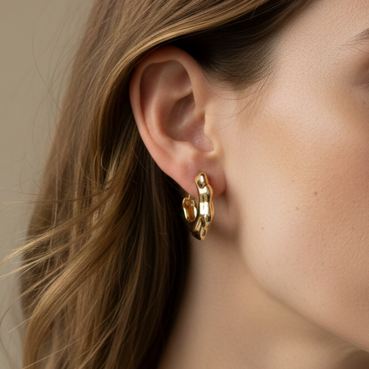 Small gold hoop earrings with a wavy design